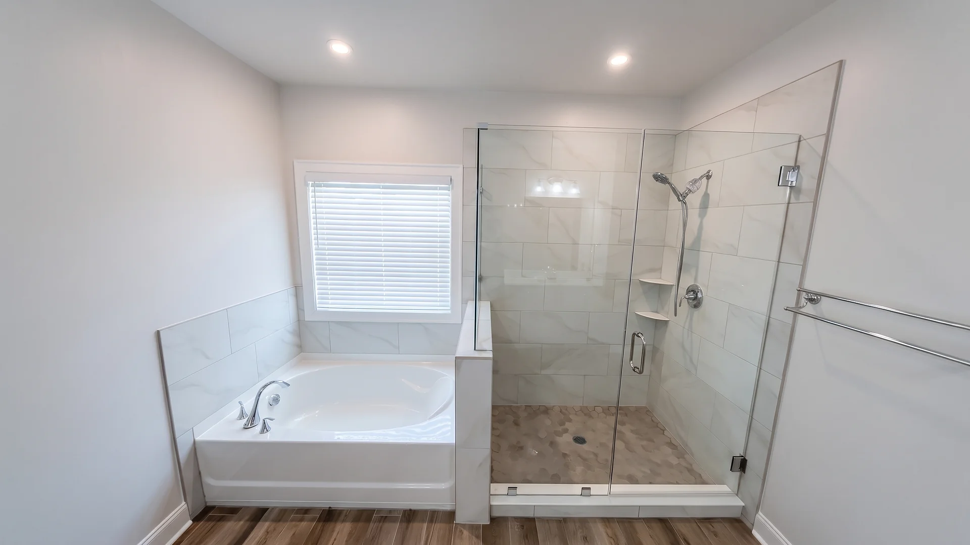 Remodeled bathroom with a drop-in tub and a tiled glass walk-in shower